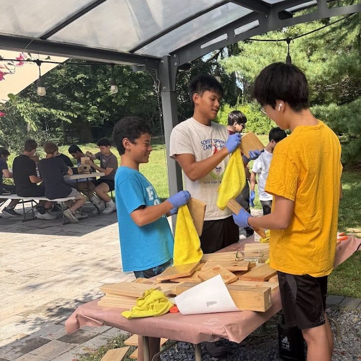 Scouts building nest boxes at a table